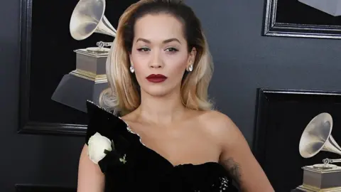 Getty Images Musicians like Rita Ora wore a white rose to the 2018 Grammys to protest against sexual harassment in the music industry