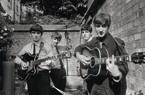 Terry O'Neill / Iconic Images The Beatles in the backyard of the Abbey Road Studios, in London in the early 1960s