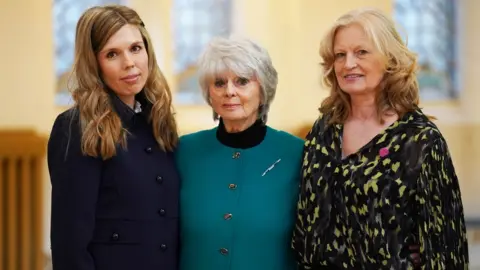 PA Media Carrie Johnson (left), Joanna Simpson's mother Diana Parkes and Hetti Barkworth-Nanton