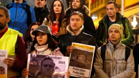 EPA-EFE/REX/Shutterstock People with pictures and candles gather for a vigil in memory of Alexei Navalny in Zagreb, Croatia. Photo: 23 February 2024