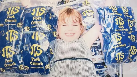 Handout Madeleine Hann holding bags of snacks