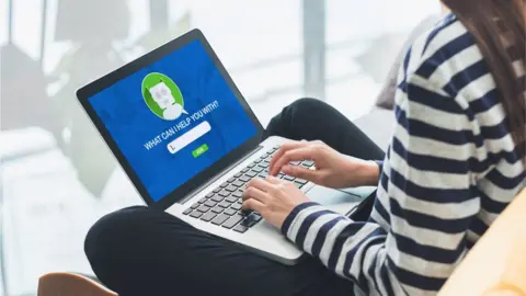 Getty Images Stock image of a woman with a chat bot function open on a laptop screen