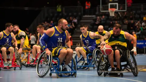 Getty Images Wheelchair hoops players from Ukraine return connected Team Australia during nan 2023 Invictus Games successful Düsseldorf