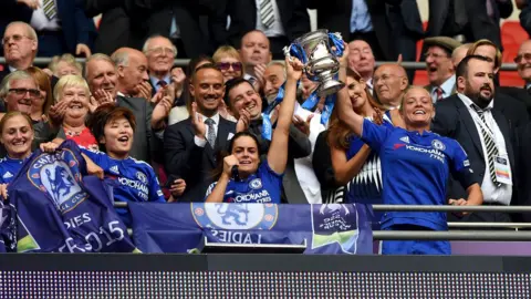 Darren Walsh/Chelsea FC Chelsea's Claire Rafferty (centre) and Katie Champman (right) celebrate with the trophy