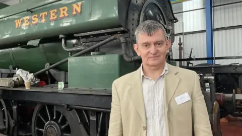 Antony Bartlam in front of a locomotive