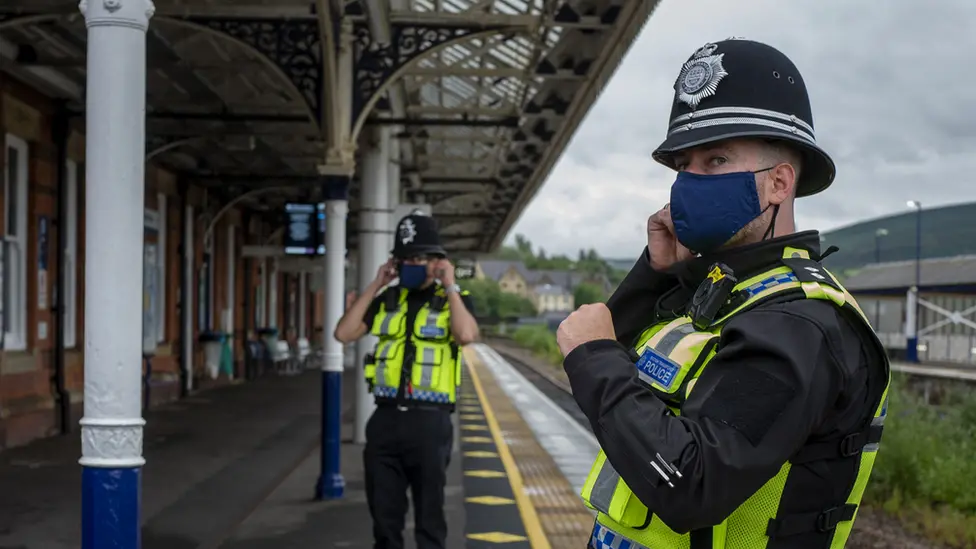 Getty Images Police wear face masks at station