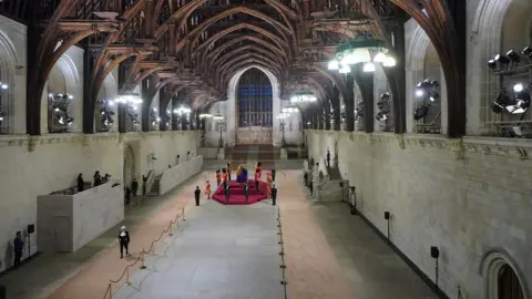 PA Media Black Rod walks through a near empty Westminster Hall at the end of the Queen's lying-in-state