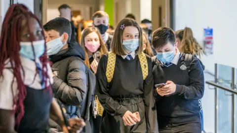 PA Media Students at St Columba's High School, Gourock, wear protective face masks as they head to lessons as the requirement for secondary school pupils to wear face coverings when moving around school comes into effect from today across Scotland.