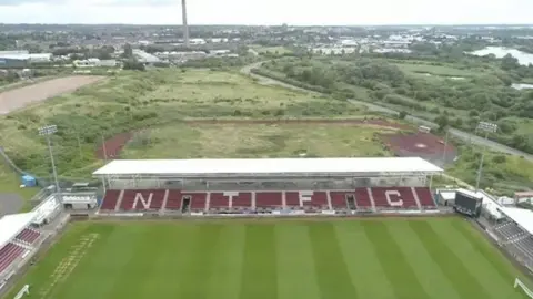 BBC Aerial shot of land behind Northampton Town's unfinished East Stand which is at the centre of a legal dispute