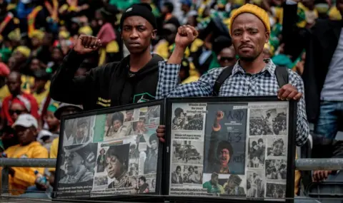AFP Mourners with raised clinched fists stand watching from the stands of the full 37,500-seater Orlando Stadium, in the township of Soweto, the funeral of the late anti-apartheid champion Winnie Madikizela-Mandela, concluding 10 days of national mourning on April 14, 2018, in Johannesburg. South Africans turned out in their thousands to bid final goodbyes to anti-apartheid icon and Nelson Mandela's former wife who was laid to rest with full state honours. Winnie Mandela, who died in Johannesburg aged 81 on April 2 after a long illness, has been celebrated for helping keep Nelson Mandela's dream of a non-racial South Africa alive while he was behind bars for 27 years.