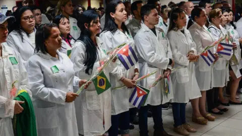 AFP Cuban doctors at welcome ceremony at Havana airport after return from Brazil - 23 November