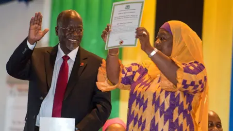 AFP Tanzania's President-elect John Magufuli (L) gestures as Vice President-elect Samia Suluhu holds up a certificate during the official election announcement ceremony in Dar es Salaam October 30, 2015.