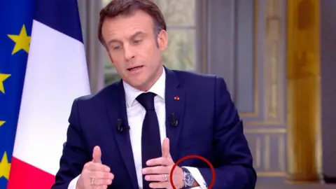 Macron wearing a watch on his left wrist