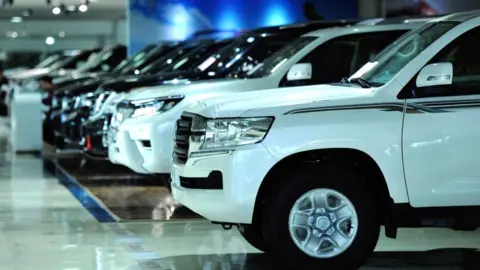 Getty Images Cars in show room in China