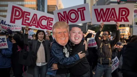 Ed Jones/Getty Demonstrators dressed as North Korean leader Kim Jong-Un (R) and US President Donald Trump (L) embrace during a peace rally in Seoul on November 5, 2017