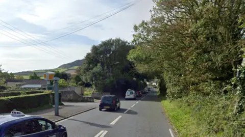 Google A Google streetview image of a blue car passing a yellow speed camera on the A35 at Chideock 