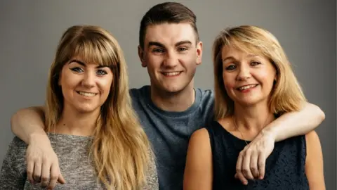 Greg Funnell/ British Heart Foundation Jim Lynskey with his twin sister Grace (left) and mother Collette (right)