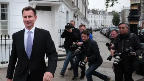 AFP Jeremy Hunt being pursued by the press in 2012