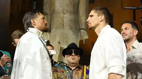 Oleksandr Usk and Rico Verhoeven face off at a news conference
