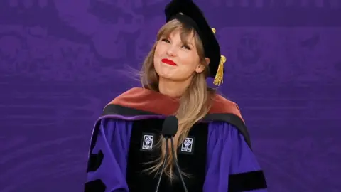 Getty Images Taylor Swift delivers the New York University 2022 Commencement Address at Yankee Stadium on May 18, 2022 in New York City