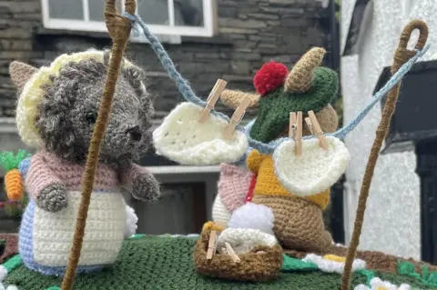 Clare Skeggs Close up of hedgehog and rabbit toy with crocheted washing line