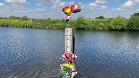 Mark Ansell/BBC Tributes left at the scene