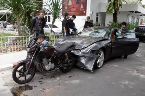 Reuters Policemen examine a damaged Ferrari at the home of the late Red Bull founder Chaleo Yoovidhaya in Bangkok, Thailand 3 September 2012.