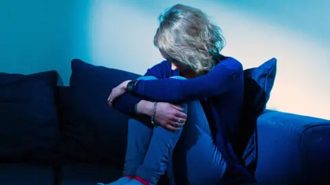 PA Woman sat on settee