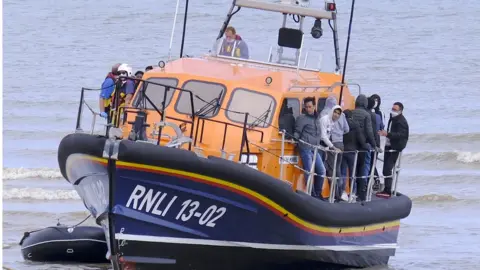 STEVE FINN Migrants on a boat in the Channel