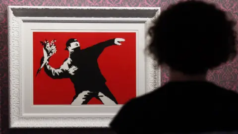 Banksy loses battle with greetings card firm over 'flower bomber 