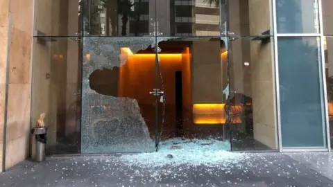 Reuters Broken doorway at the building where Lebanese Prime Minister-designate Najib Mikati lives in Beirut (15 August 2021)