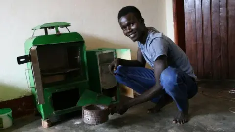 Lawrence sitting next to the original Sparky Dryer prototype