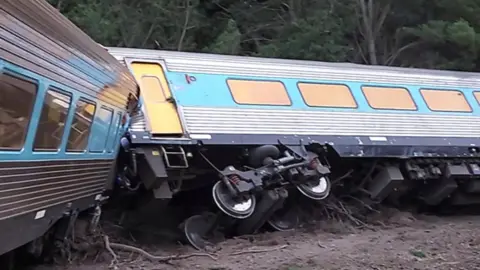 BBC The derailed carriages of a passenger train that was travelling from Sydney to Melbourne, Australia