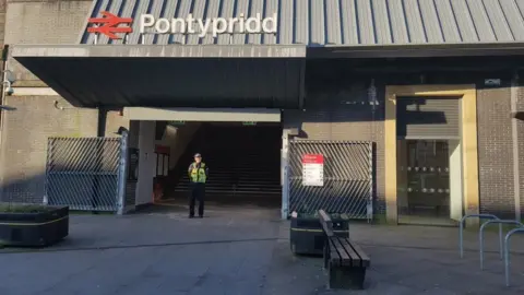 South Wales Police police officer standing outside Pontypridd station