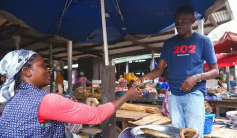 Market vendor and Mark Impraim