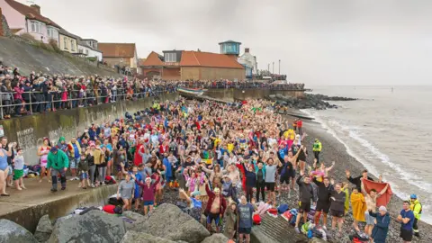 Chris Taylor Swimmers pose before launching into the sea at Sheringham, Norfolk in 2020