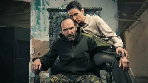 Oliver Rosser Ralph Fiennes and Indira Varma