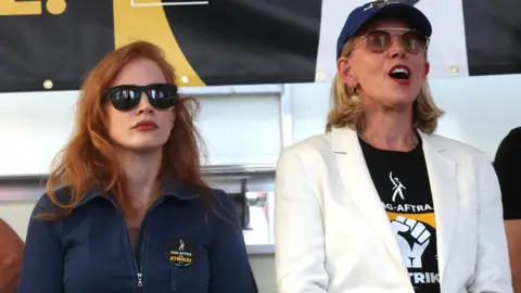 Reuters Actors Jessica Chastain and Christine Baranski attend a SAG-AFTRA actors strike rally in Times Square in Manhattan in New York City, New York, U.S., July 25, 2023