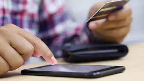 Getty Images Someone entering card details into a phone