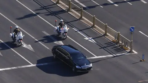 Reuters A vehicle that is part of a motorcade that is believed to be carrying North Korean leader Kim Jong Un makes its way through central Beijing