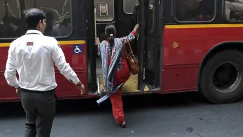 Getty Images An Indian woman boards a bus