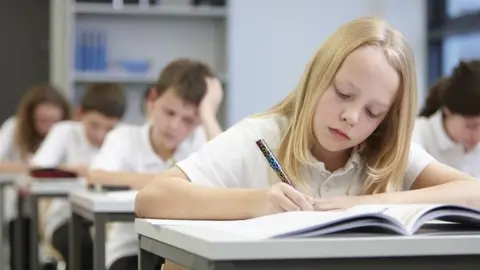 Getty Images Children sitting an exam