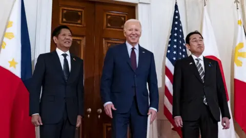 US President Joe Biden, center, with Ferdinand Marcos Jr., Philippines' president, left, and Fumio Kishida, Japan's prime minister, right,