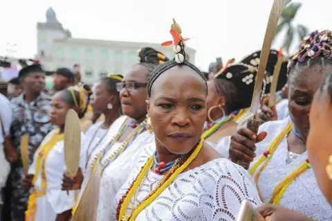 AKINTUNDE AKINLEYE / REUTERS Worshippers of Osun dressed in matching white participate in a procession in Osogbo.