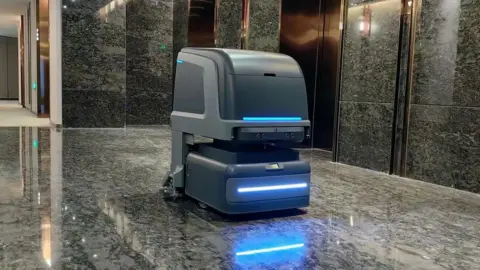 Yunji Yunji's robot in a hotel lobby by the lifts