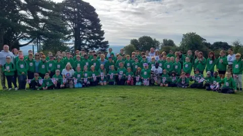 Group picture of kids and volunteers at the camp