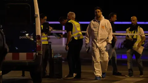 AFP Police officers, one in a forensic suit