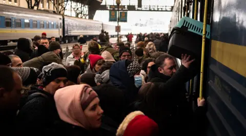 Getty Images Refugees struggle to board a train at Lviv's main station, Ukraine, March 9 2022