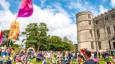 GARRY JONES / Camp Bestival A crowd of festival-goers next to Lulworth Castle