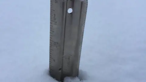 Joanna Weenink A snow stick shows 20cm of snowfall in the Brecon Beacons